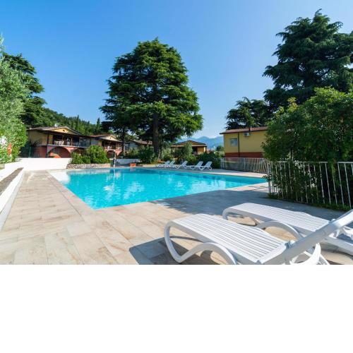 Apartment on Lake Garda with pebble beach pier for boat three swimming pools