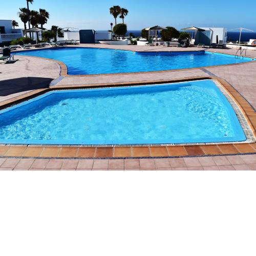 Puerto del Carmen center - New Apartment by the pool and private parking
